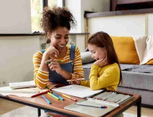 Caucasian,Little,Girl,Spending,Time,With,African,American,Baby,Sitter. Caucasian little girl spending time with african american baby sitter. They are drawing, learning how to draw, sitting on the floor. Children education, leisure activities, babysitting concept